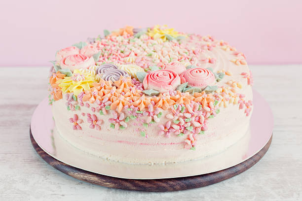 istock Pastel pink cake decorated with cream flowers 532519973