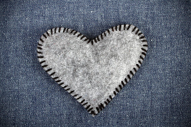 istock gray heart on blue fabric background 532520267