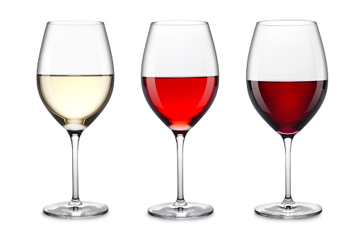 Front view of a glass full of red wine with a wine bottle isolated on white background. Studio shot taken with Canon EOS 6D Mark II and Canon EF 100 mm f/ 2.8