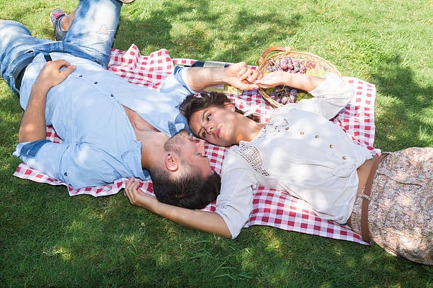 istock Young couple relaxing laying on grass. 532521869