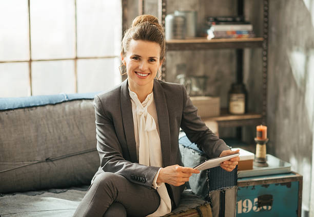 istock happy business woman using tablet pc in loft apartment 532521871