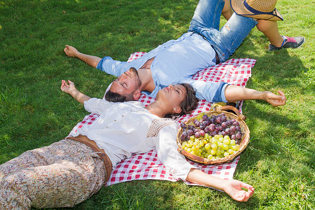 istock Young couple relaxing laying on grass. 532522119