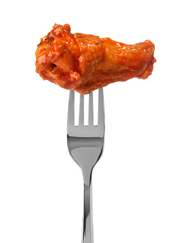 Hot wing drumstick on fork on white background.  Please see my portfolio for other food and drink images.