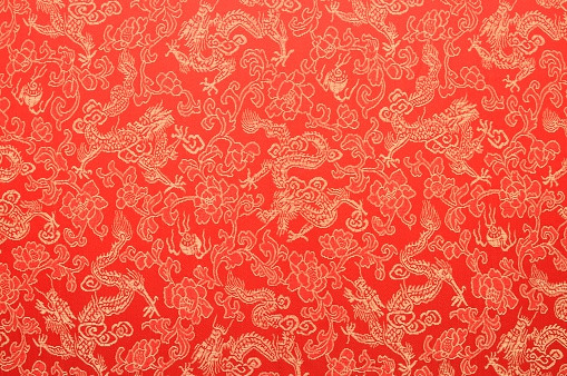 Fragment of red chinese silk with golden dragons and flowers