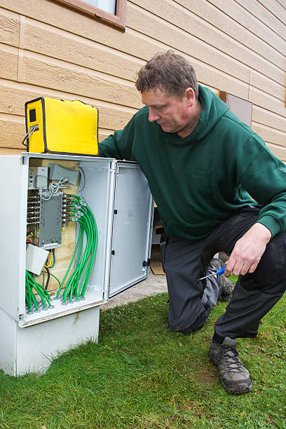 istock Telecommunication engineer checks a network box outside a property. 532528267