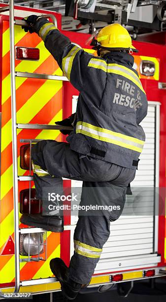 Manning The Fire Engine Stock Photo - Download Image Now - 2015, Adult, Adults Only