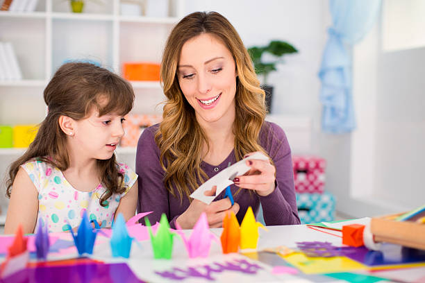 istock Mother and daughter making origami. 532530225