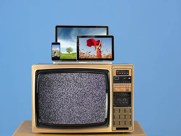 istock Modern computers and smart phones on old fashioned television 532530659
