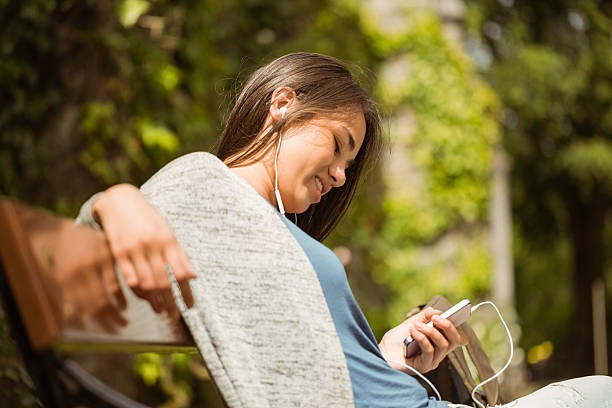 istock Smiling student sitting on bench in college 532532667