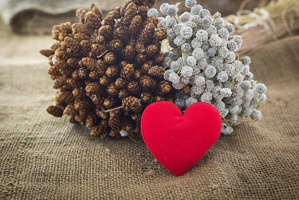 istock heart on jute and dry flower background 532533315