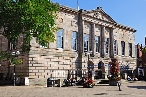 Stafford, United Kingdom - September 11, 2014: Shire Hall Gallery in Market Square with people sitting relaxing in the sunshine, Stafford, Staffordshire, England, UK, Western Europe.