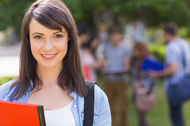istock Pretty student smiling at camera outside on campus 532534771