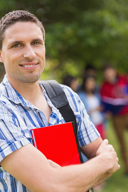 istock Happy student smiling at camera outside on campus 532534891