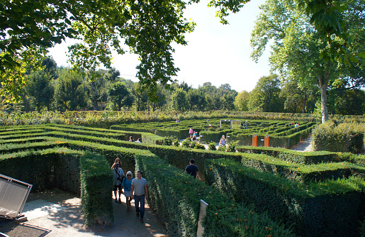 Vienna, Austria - September 18, 2012: Tourists walk in the beatiful park in Schoenbrunn of Vienna in sunny day. 