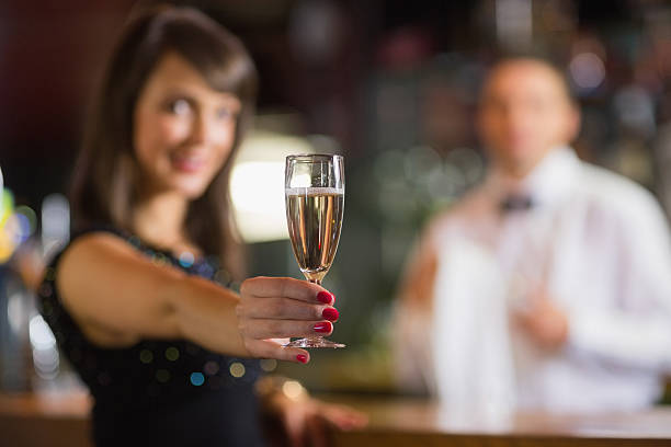 istock Pretty brunette smiling at camera with champagne 532545913
