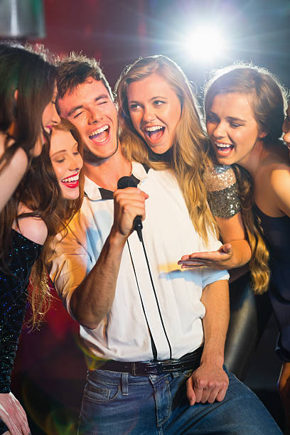 istock Happy friends singing karaoke together 532546289