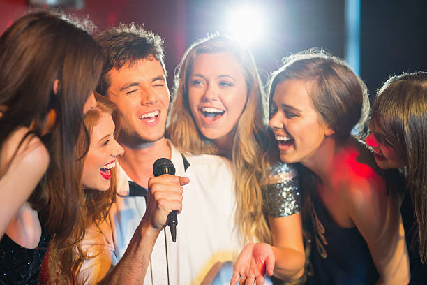 istock Happy friends singing karaoke together 532546309