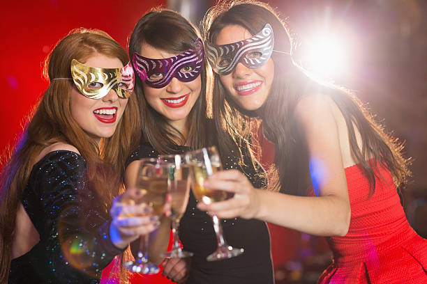 istock Friends in masquerade masks toasting with champagne 532546439