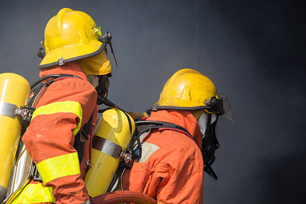 istock 2 firefighters in operation and dark smoke background 532546546