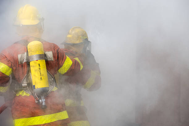 istock 2 firemen in operation surround with smoke 532546646