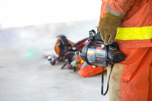 fireman hand in glove hold oxygen mask