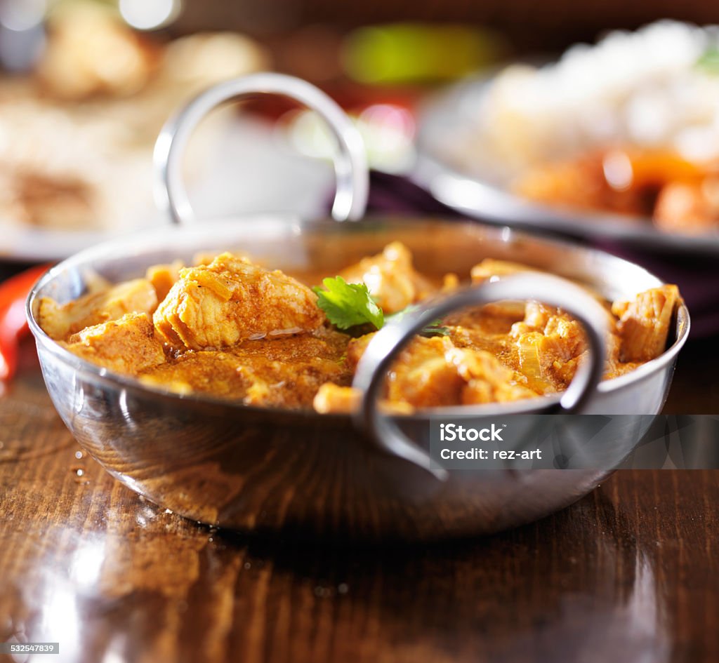 indian butter chicken curry in balti dish with basmati rice indian butter chicken curry in metal balti dish with basmati rice, shot with selective focus Butter Chicken Stock Photo