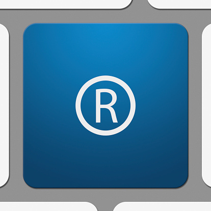 Close-up of a square, flat keyboard key with a registered trademark symbol - a capital R within a circle. Intellectual property concept, relating to the importance of protecting known brands against piracy, and to marketing and promotion in general. Stylised, flat design.