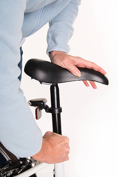 istock Woman sets height of  bicycle saddle before cycling 532548873