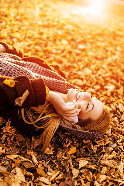 istock Talking on the phone in autumn leaves. 532549385