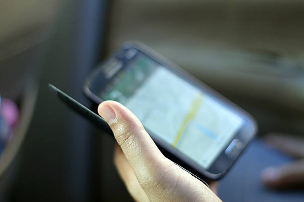 istock man hand holding a smart phone with a GPS navigator 532549885