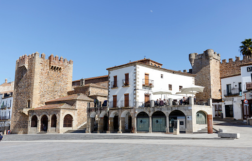 Caceres, Spain - March 16, 2016: Square of Caceres, Bujaco Tower, Chapel of Peace and bow of the Star in the Plaza Mayor.