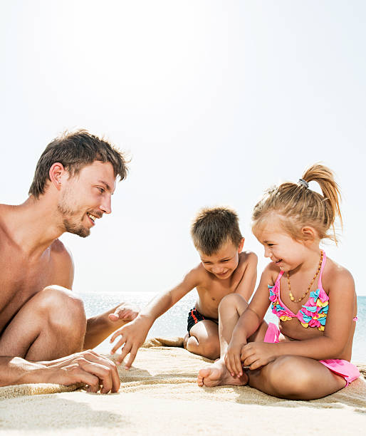 istock Father and children on the beach. 532550699