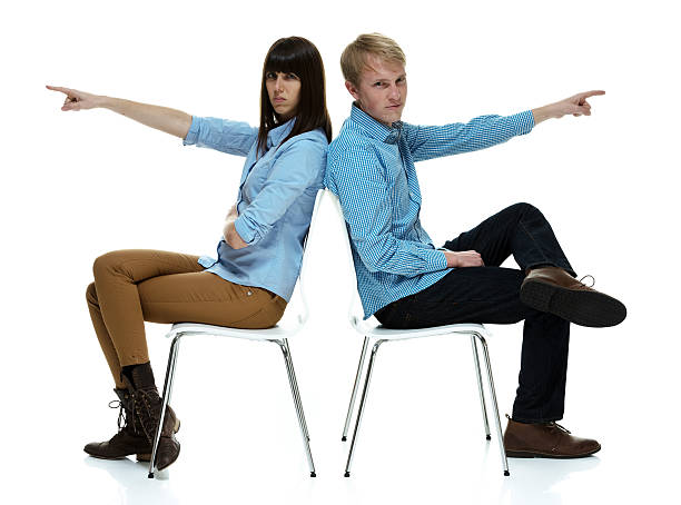 istock Angry couple sitting and pointing away 532550928