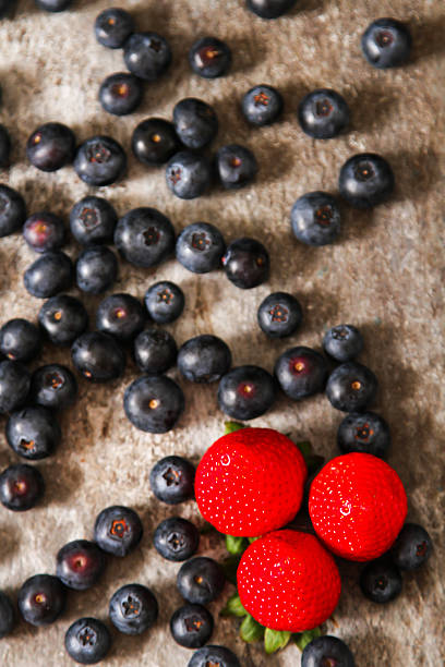 istock blueberries and strawberries on a plate stone background 532551282