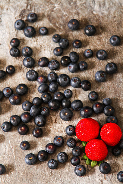 istock blueberries and strawberries on a plate stone background 532551326