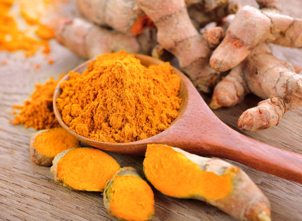 istock Turmeric and turmeric powder on wooden background 532552284