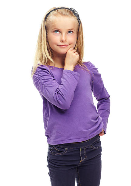 Sweet little blonde girl posing thoughtfully against a white background