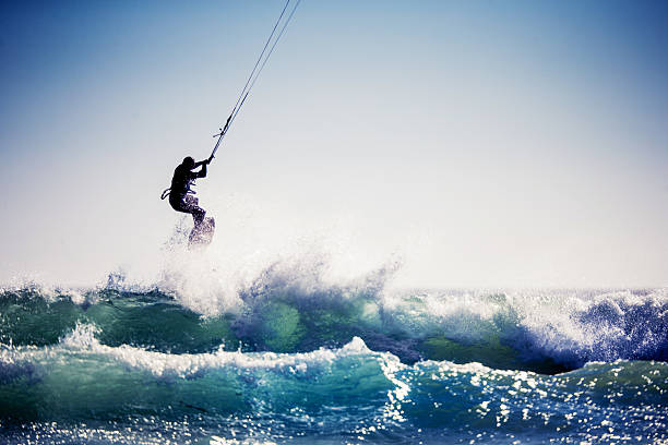 Kiteboarding Kiteboarder jumping the waves in Cape Town. kiteboarding stock pictures, royalty-free photos & images