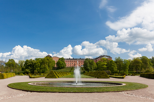 Uppsala, Sweden - May 20, 2016 : Distant view of the Uppsala Castle from the Uppsala botanic garden including fountains.