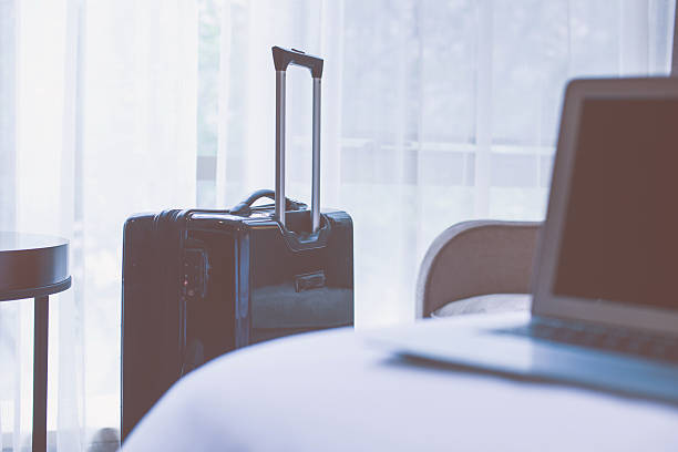 istock Hotel room with laptop and luggage 532557594