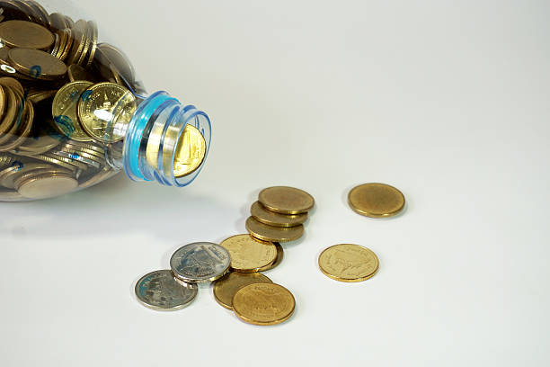istock Thai baht  coins falling from recycle bottle, close-up 532558308