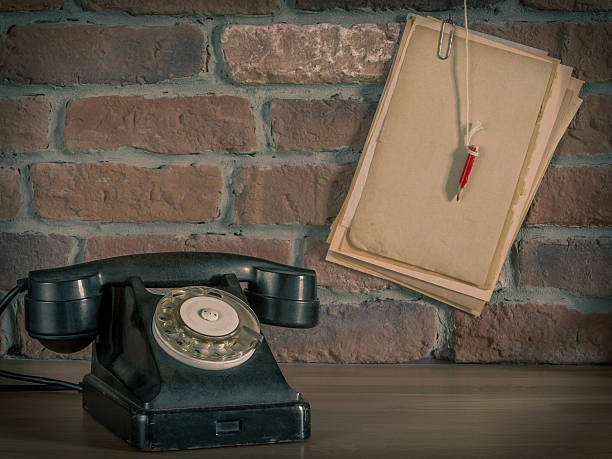 istock Old telephone and paper with pencil 532558454