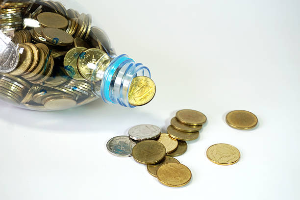 istock Thai baht  coins falling from recycle bottle 532558604