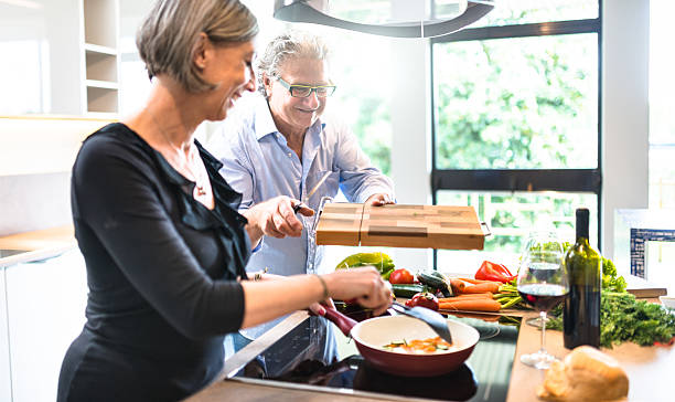 istock busy mature couple cooking in the kitchen 532559154
