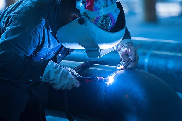 istock Worker welding metal piping using tig welder 532560208