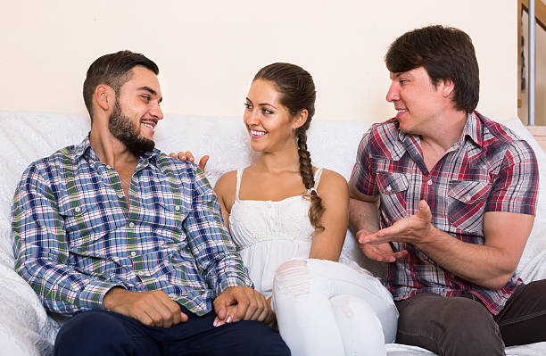 happy adult partners in home interior Three happy european adult partners in home interior menage trois stock pictures, royalty-free photos & images