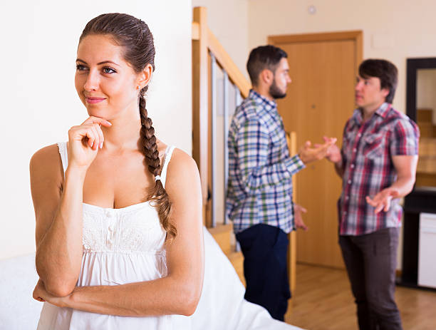 Problems of love triangle A young woman and two men: problems of love triangle menage trois stock pictures, royalty-free photos & images