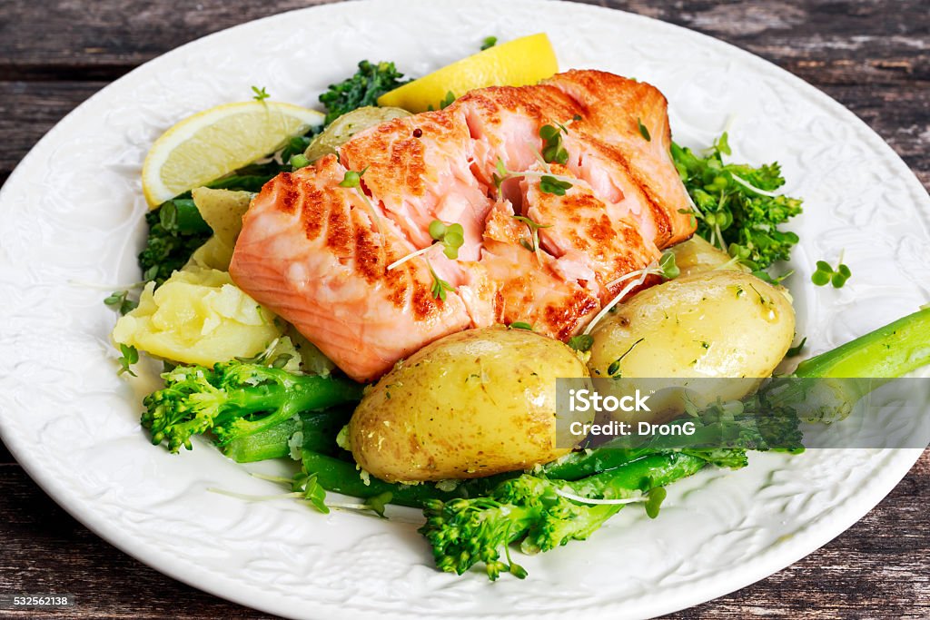 Pan fried Salmon Served with potatoes and tenderstem broccoli. Pan fried Salmon Served with potatoes and tenderstem broccoli Sockeye Salmon Stock Photo