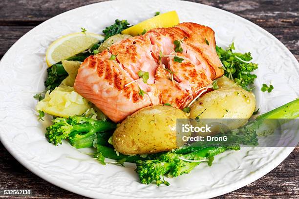 Pan Fried Salmon Served With Potatoes And Tenderstem Broccoli Stock Photo - Download Image Now