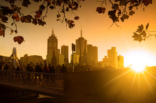 People crossing the Evan Walker bridge from Southbank, Melbourne, at sunrise.